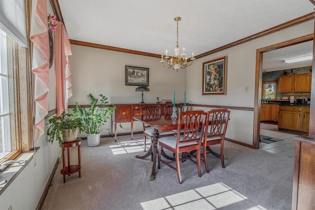 dining area with crown molding, a healthy amount of sunlight, baseboards, and light colored carpet