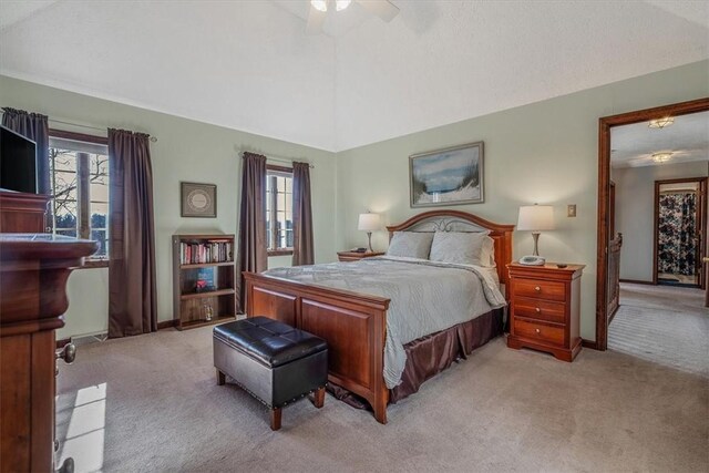 bedroom featuring light carpet, multiple windows, and lofted ceiling