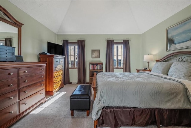 bedroom with carpet floors, multiple windows, and vaulted ceiling