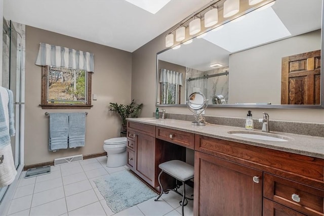 full bathroom featuring a skylight, a sink, visible vents, and a shower stall