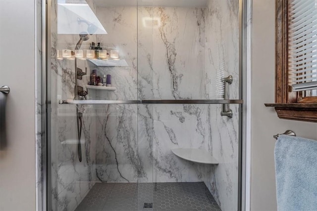 bathroom with a marble finish shower