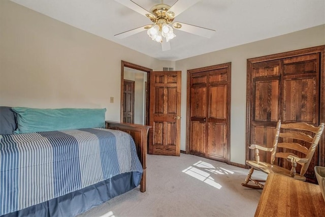 bedroom featuring light carpet, ceiling fan, and baseboards