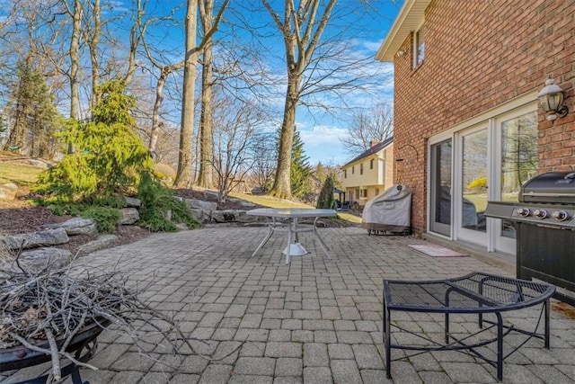 view of patio with outdoor dining area and grilling area