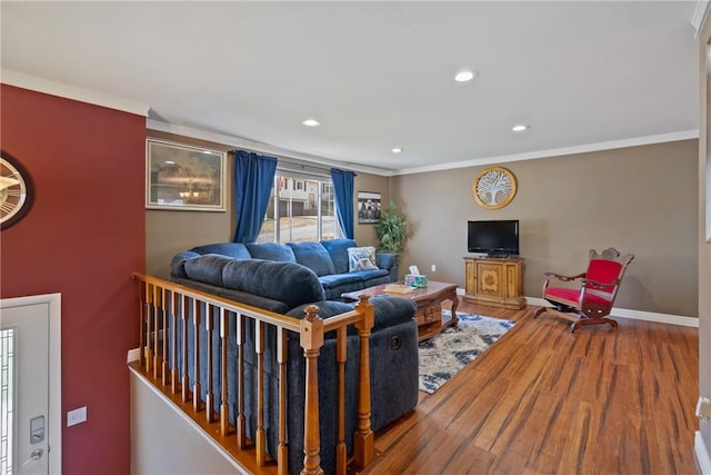 living room featuring ornamental molding, recessed lighting, baseboards, and wood finished floors