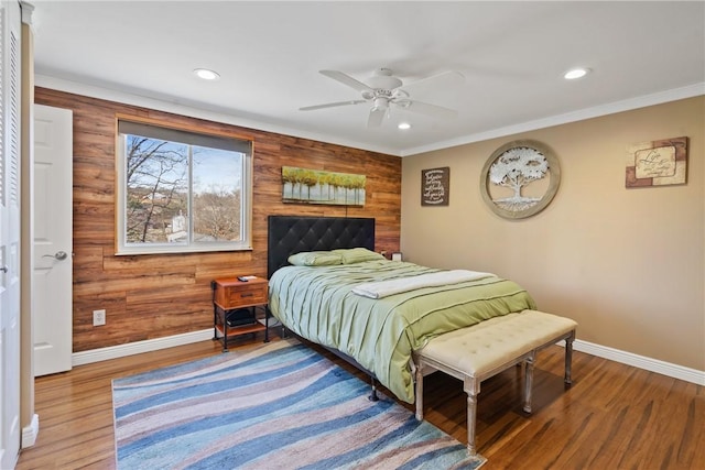 bedroom featuring baseboards, wood finished floors, and recessed lighting