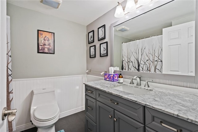 full bathroom with visible vents, wainscoting, vanity, and toilet