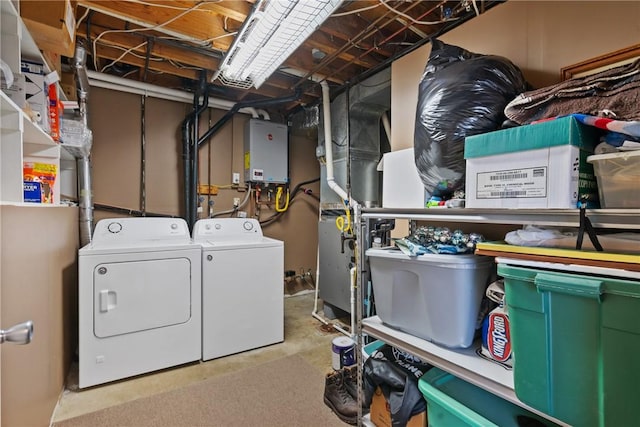 laundry room featuring washing machine and dryer, laundry area, water heater, and heating unit