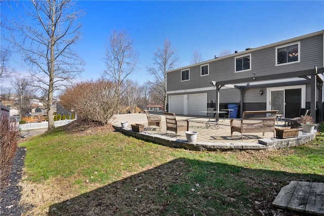 rear view of property with a yard, a patio area, and fence