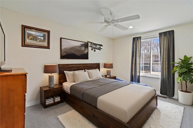 bedroom featuring light carpet, ceiling fan, and baseboards