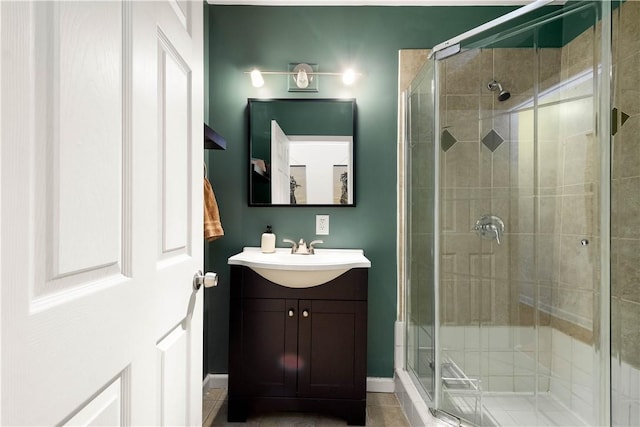 full bathroom featuring a shower stall, vanity, and baseboards