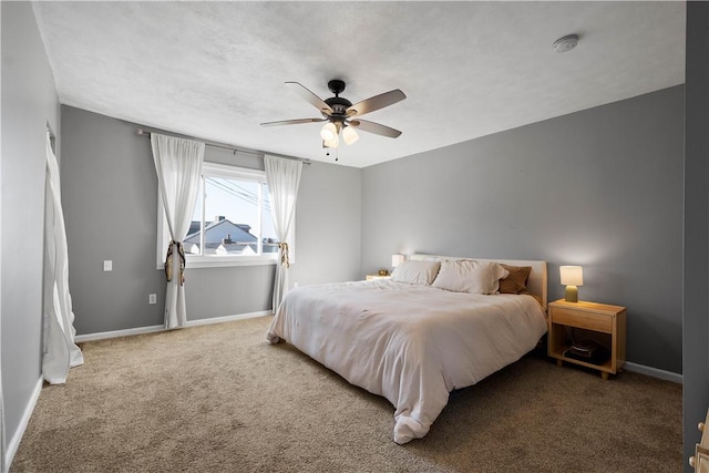 carpeted bedroom featuring a ceiling fan and baseboards