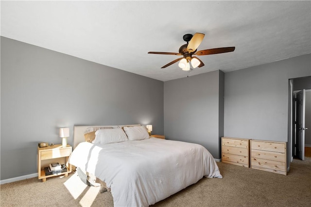 carpeted bedroom featuring a ceiling fan and baseboards