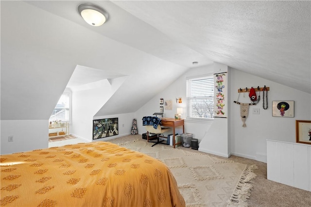 carpeted bedroom featuring vaulted ceiling, a textured ceiling, and baseboards