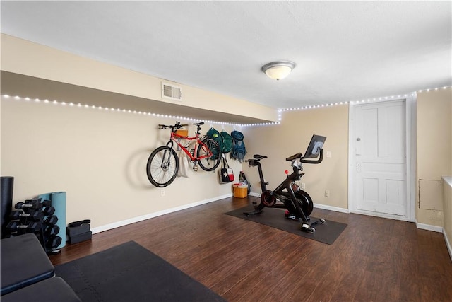 workout room with visible vents, baseboards, and wood finished floors