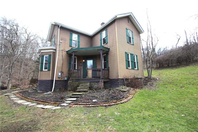 view of front of home with a front yard and covered porch