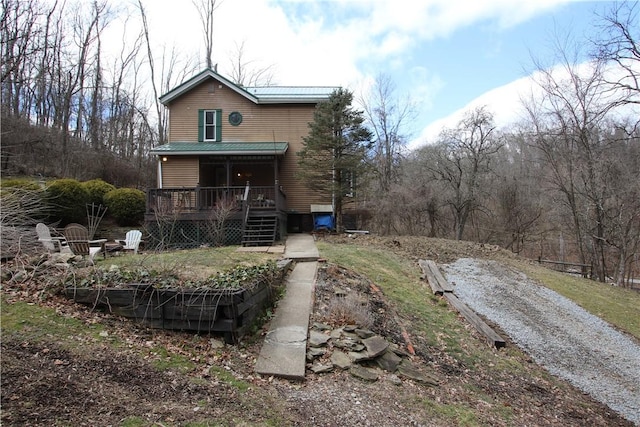 view of front of home with gravel driveway and a deck