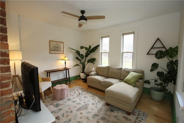 living room featuring wood finished floors and a ceiling fan