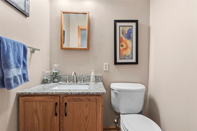 bathroom with toilet and vanity