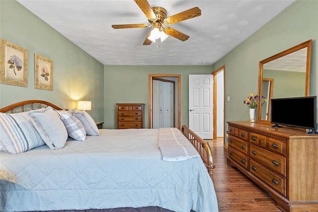 bedroom with a closet, a ceiling fan, and wood finished floors