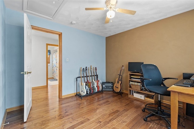 office space featuring ceiling fan, wood finished floors, and baseboards