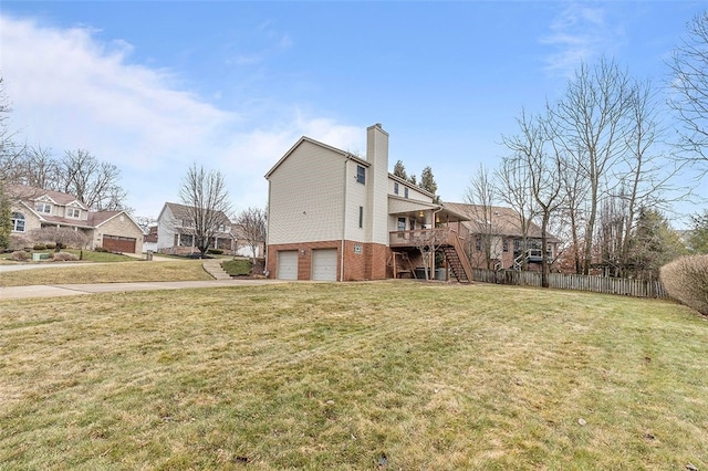 rear view of house with a chimney, stairway, fence, a yard, and brick siding