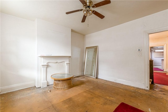 unfurnished living room with a ceiling fan, concrete floors, and baseboards