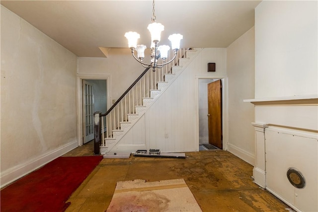 entryway featuring stairway and an inviting chandelier