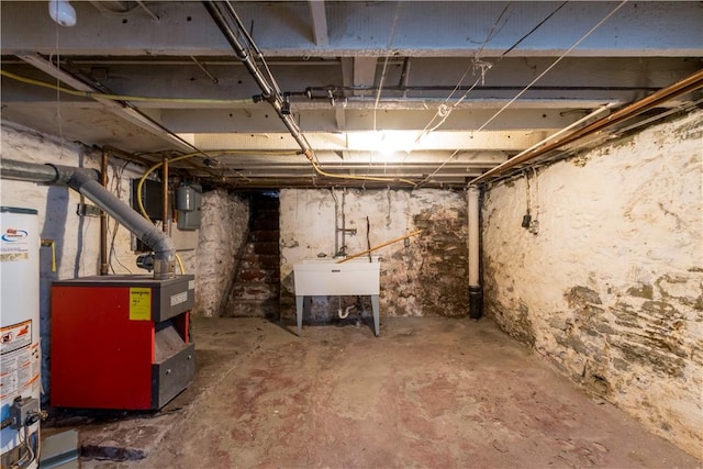 unfinished below grade area featuring gas water heater, a heating unit, and a sink