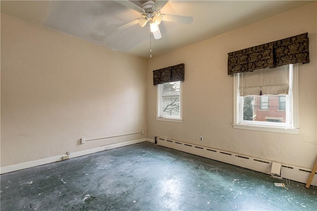 spare room with a baseboard heating unit, concrete flooring, baseboards, and a ceiling fan