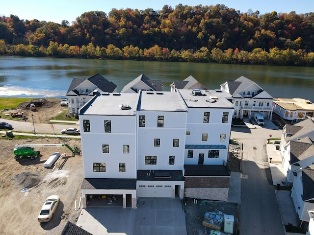 aerial view with a water view and a view of trees