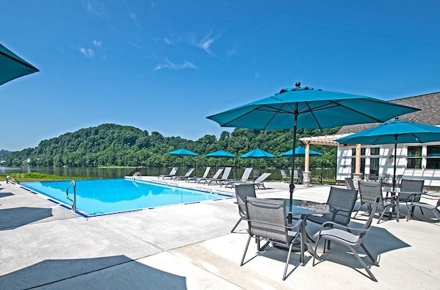 pool with fence and a patio area