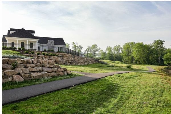 surrounding community with fence and a yard