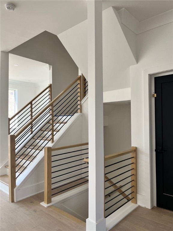 stairs featuring wood finished floors