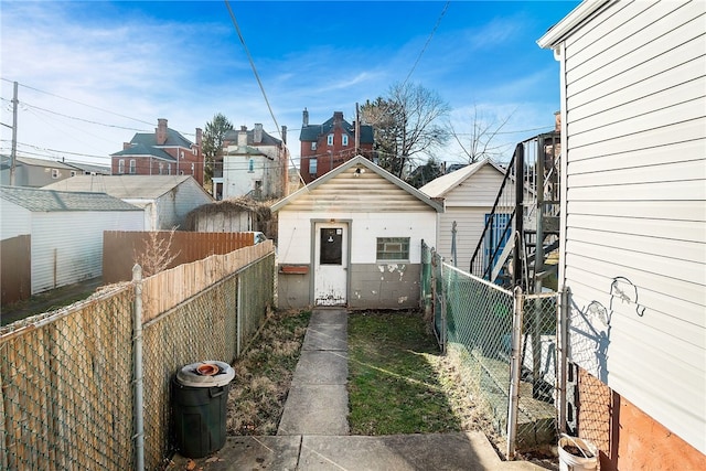 exterior space featuring an outbuilding and a fenced backyard