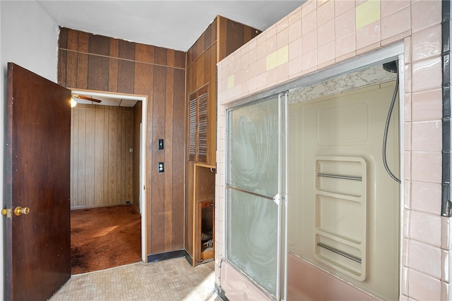 full bath with wooden walls and a shower