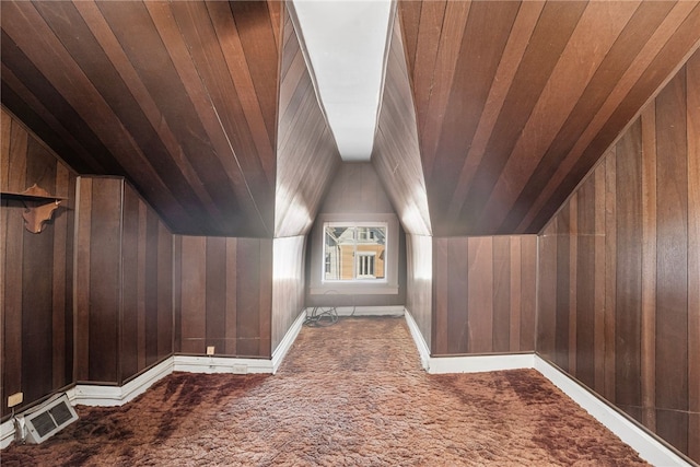 bonus room featuring lofted ceiling, wood ceiling, visible vents, and wooden walls