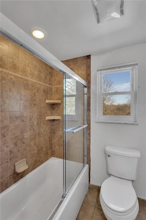 full bathroom featuring visible vents, toilet, enclosed tub / shower combo, baseboards, and tile patterned floors