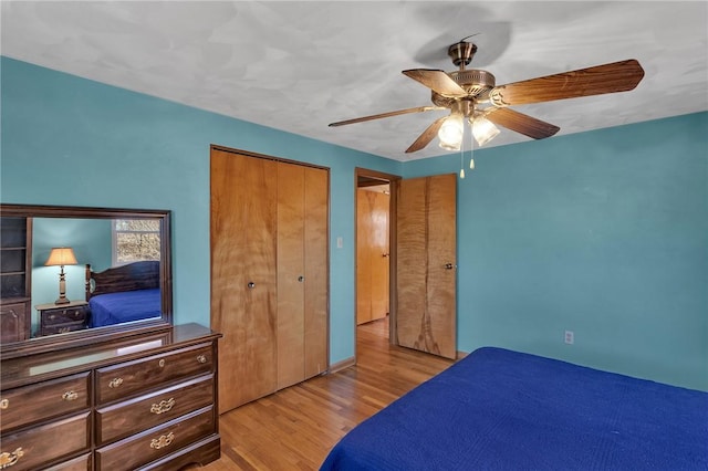 bedroom featuring a closet, ceiling fan, and wood finished floors