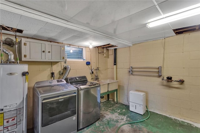 laundry room with washing machine and dryer, gas water heater, and laundry area