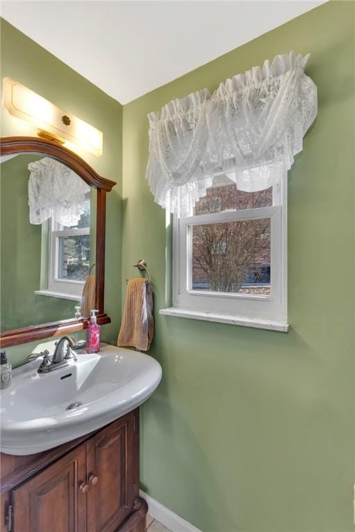 bathroom with baseboards and vanity