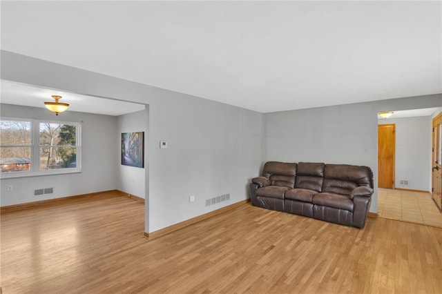 living room with light wood-type flooring and visible vents