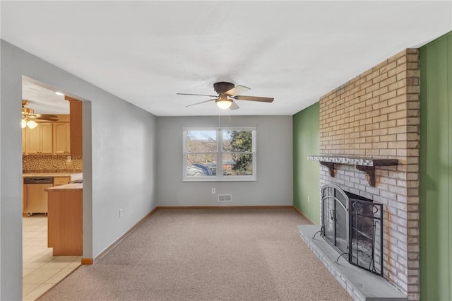 unfurnished living room featuring a fireplace, baseboards, a ceiling fan, and light colored carpet