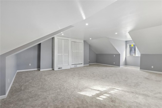 additional living space with recessed lighting, carpet flooring, vaulted ceiling, and baseboards