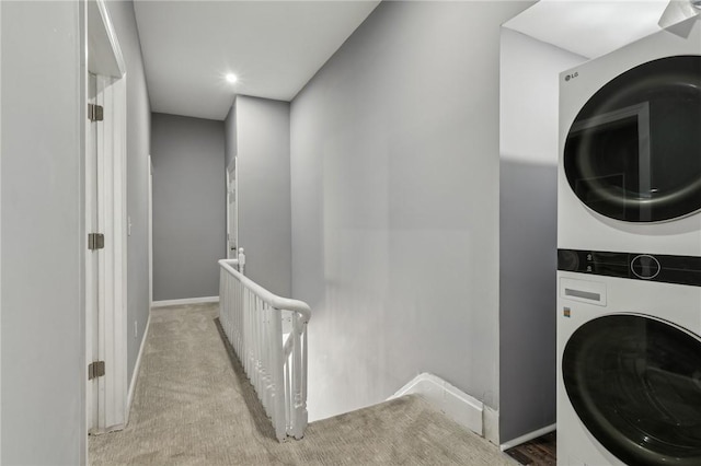 washroom with recessed lighting, laundry area, carpet floors, baseboards, and stacked washer and clothes dryer