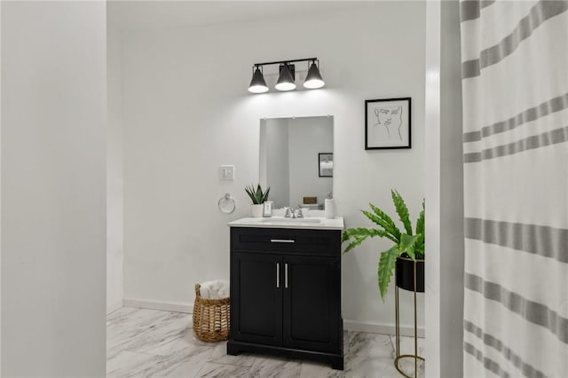 bathroom featuring marble finish floor, baseboards, and vanity