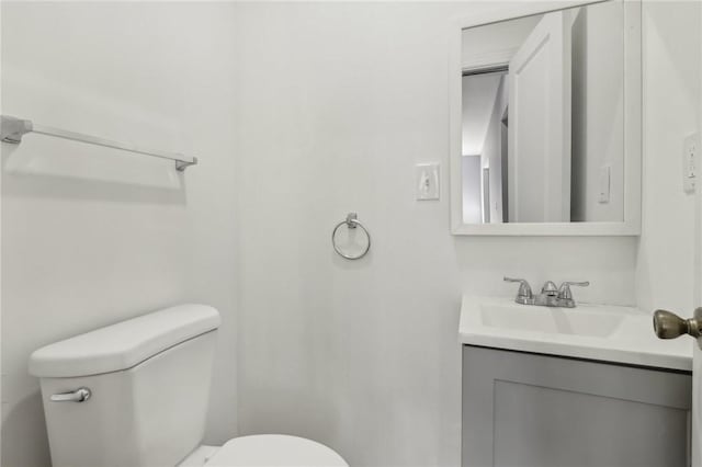 bathroom featuring toilet and vanity