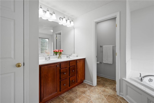 full bath featuring double vanity, a sink, a bath, and baseboards