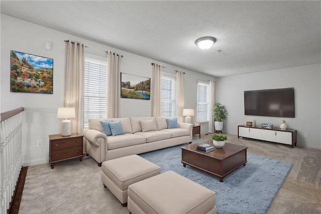 carpeted living room featuring baseboards