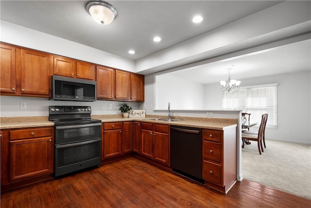 kitchen with stainless steel microwave, a sink, double oven range, a peninsula, and dishwashing machine