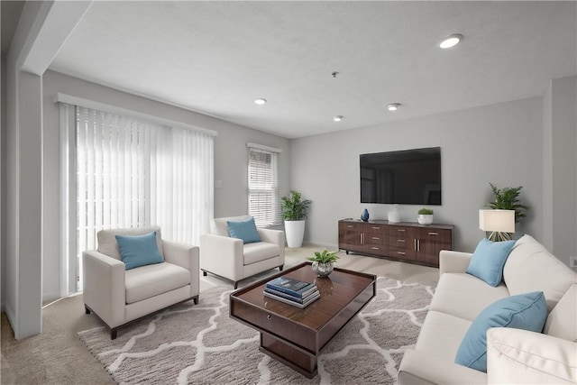 living area featuring recessed lighting and light colored carpet